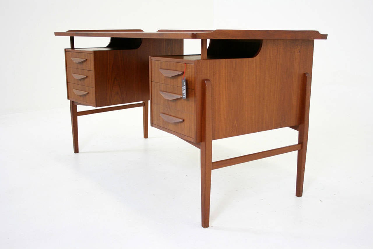 -1960’s, Danish, teak
-Sculptural organic lines, finished back
-Unique storage at back with one side showing mirrored bar and the other having two slide out drawers for desk paraphernalia
-Fantastic raised lip around perimeter of top
-Excellent