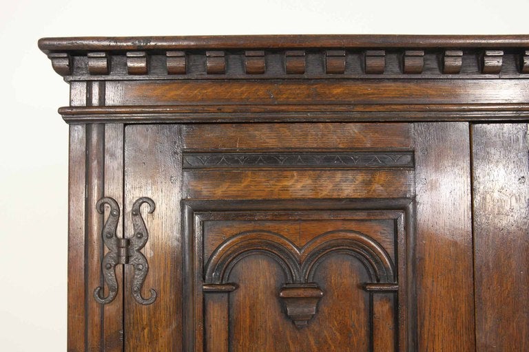 Nice quality two (2) door oak armoire with dentile cornice above two (2) three (3) panelled doors, fitted interior, hand forged exterior hinges ending on square legs.

Shipping will be $525.00 - $575.00 by Plycon.
