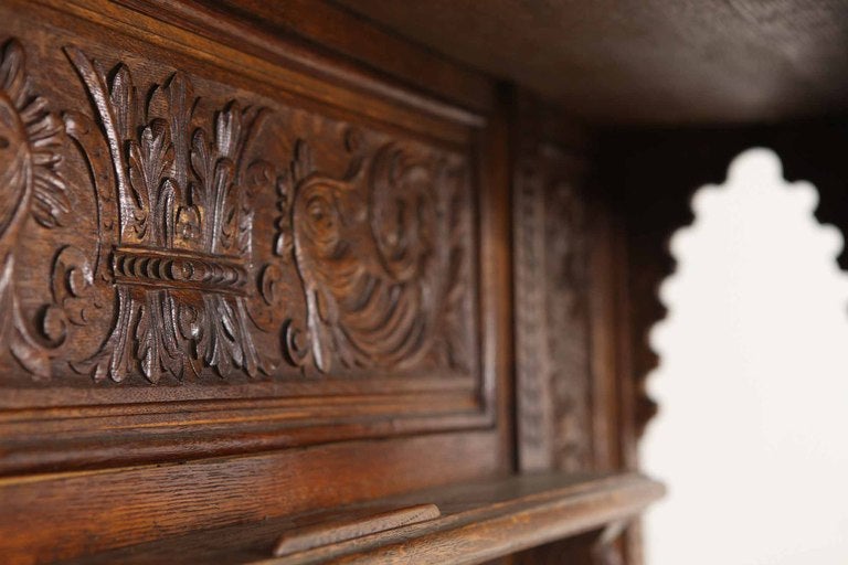 Beautiful carved oak mirror back sideboard, the projected moulded carved cornice over shelf and rectangular bevelled mirror, flanked by barley twist pillars, rectangular top above two (2) carved drawers, two (2) heavily carved doors below, enclosing