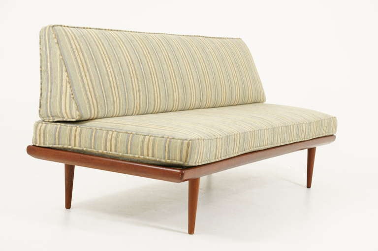 Beautiful teak sofa daybed designed by Peter Hvidt and Orla Mølgaard-Nielsen and produced by France and Daverkosen , as part of the 1960′s Minerva series. A teak framed sofa with tapered legs and a stunning cut out detailed back rest. The back of
