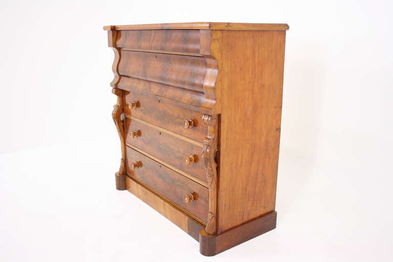 A 19th Century mahogany chest of drawers with two shaped front drawers above three graduating drawers with original mahogany knobs and mother of pearl inserts, beautiful carved columns to the front, ending on a plinth base.