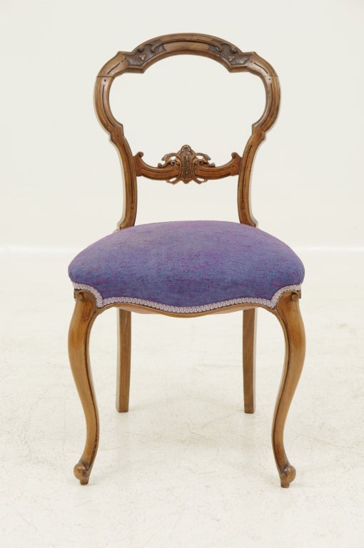 Lovely carved walnut balloon back chair with mauve upholstery with cabriole legs and heavily carved back.
