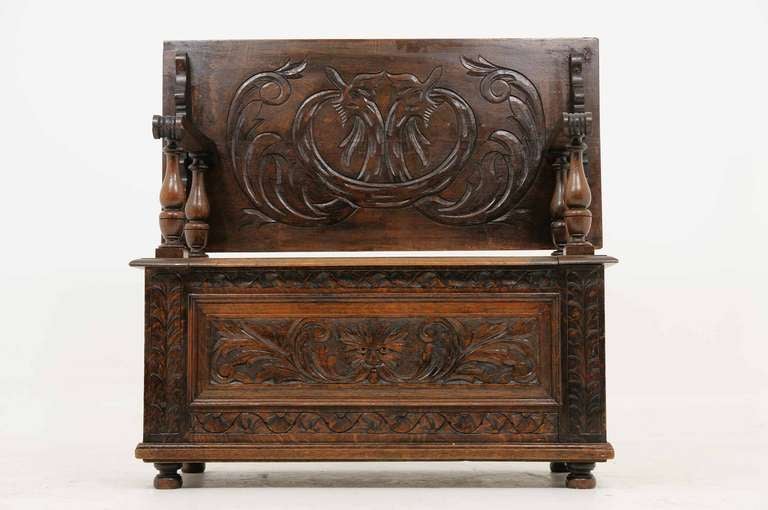 Late Victorian heavily carved oak tilt-top monks / hall bench with carved back above four (4) turned legs, above hinged top (19