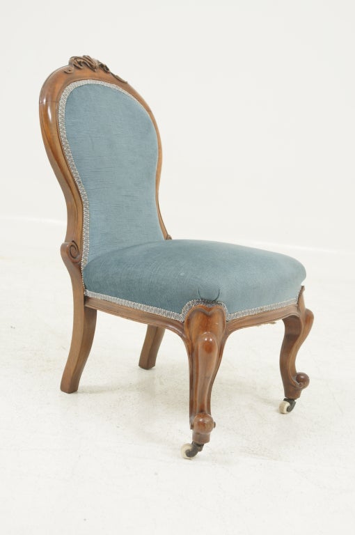 Petite Victorian child's chair with padded back and seat, raised on cabriole legs ending in ceramic castos. Smaller scaled version of a parlor chair. Shipping will be $85 by Greyhound.