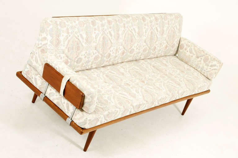 Beautiful teak sofa daybed designed by Peter Hvidt and Orla Mølgaard-Nielsen and produced by France and Daverkosen, as part of the 1950′s Minerva series. A teak framed sofa with removable arms, tapered legs and a stunning cut out detailed back rest.