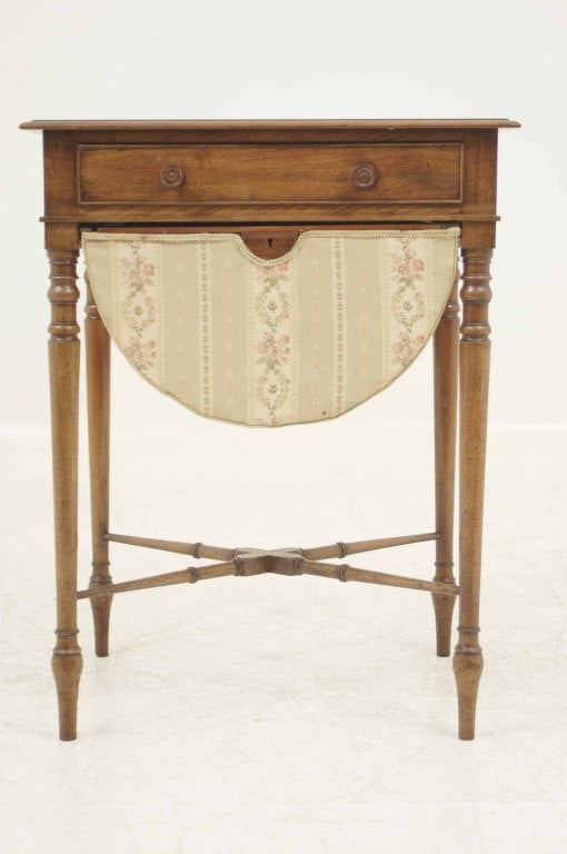 Mid 19th century mahogany work table with the moulded rectangular top above a frieze drawer above a sliding cloth covered basket, all raised on circular section legs with delicate turned cross stretchers.