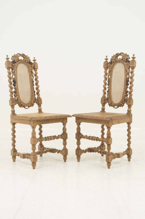 Pair of Victorian carved oak barley twist hall chairs with barley twist uprights above caned seat on barley twist legs.