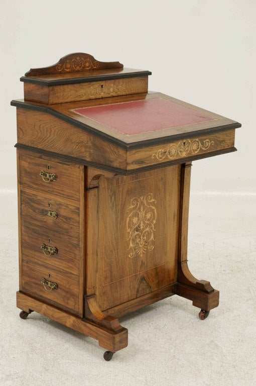Late Victorian marquetry inlaid davenport desk with hinged writing slope, opening to reveal a fitted interior, over four (4) side drawers and four (4) opposing false drawers, shaped feet ending on ceramic castors.  Shipping will be $400.00 - $425.00