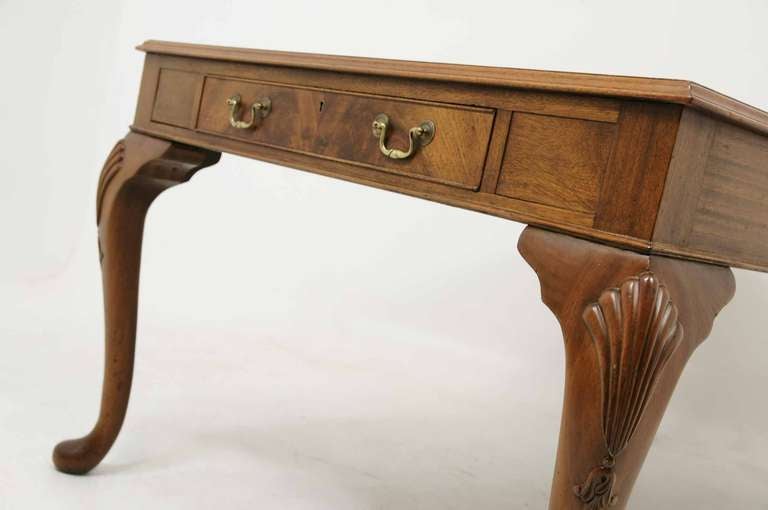 Very large mahogany writing table, the rectangular top with leather insert, single (1) drawer on one end, raised on shell carved cabriole legs.

Shipping will be $450.00 - $500.00 by Plycon.
