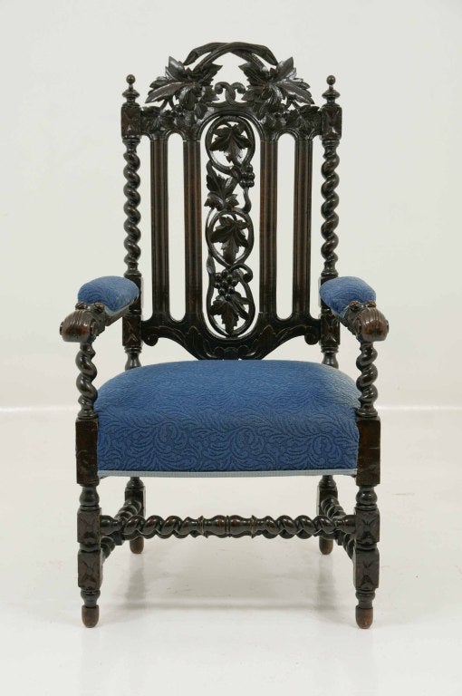 Victorian carved oak barley twist open armchair with open carved back, padded arms with padded seat, raised on block legs united by stretcher.