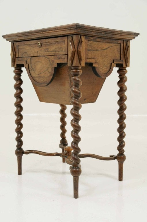 Mid Victorian rosewood sewing table, the rectangular top above a frieze drawer with a pull out bag, each side with a lunette moulding and applied lozenges on barley twist tapering legs, united by a shaped X-framed stretcher.