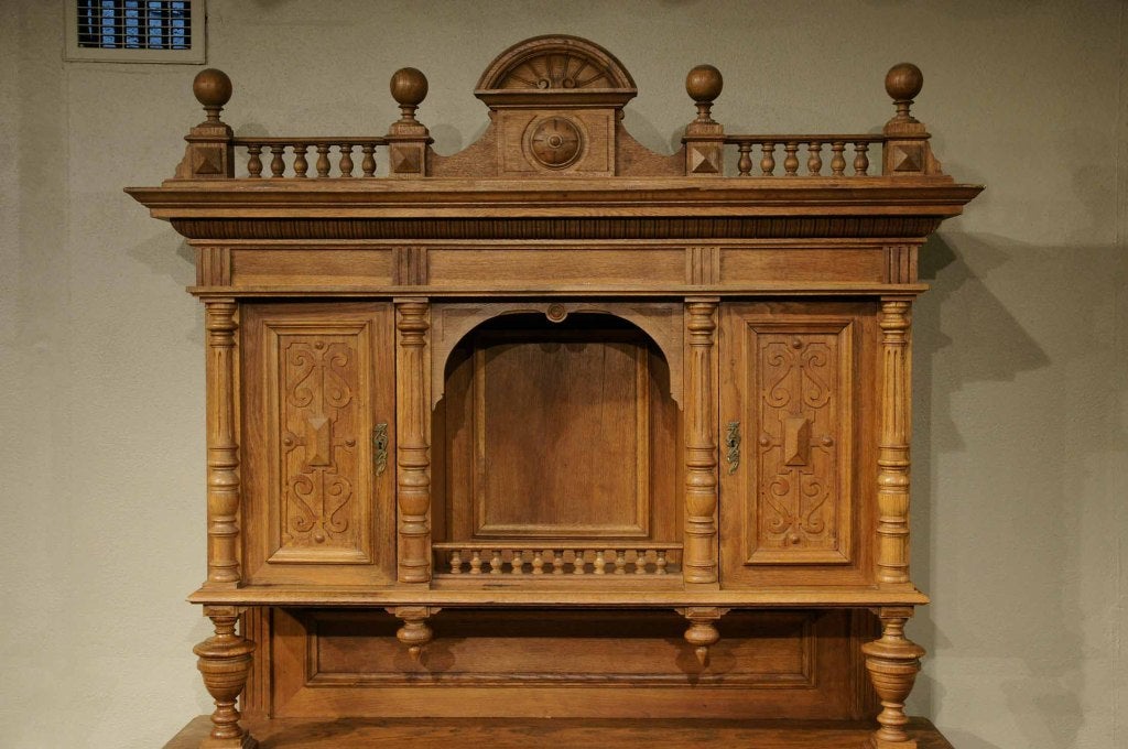 Very large oak antique French Renaissance buffet, hutch, china cabinet with carved pediment above open space, flanked by two (2) upper doors, counter top above with two (2) carved drawers above two (2) panelled doors ending on a plinth base with