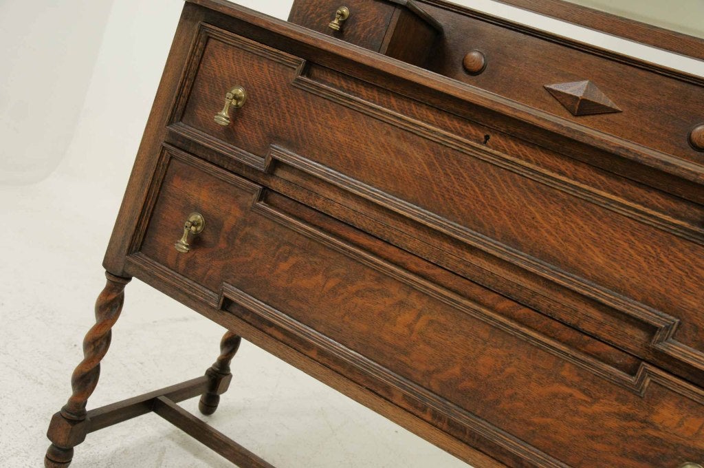Early 20th century oak swing mirror dressing table with two (2) small drawers above two (2) large drawers with brass handles, on barley twist legs, connected by cross stretcher.

Shipping will be $210.00 by Greyhound.