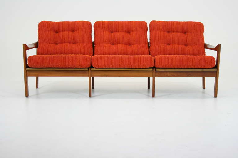 A gorgeous teak sofa set designed by Illum Wikkelso, manufactured by N.Eilersen in the 1960s. The design is straightforward and minimalist. The unique sculpted teak armrest joint which is completely visible is the highlight of the design. Also