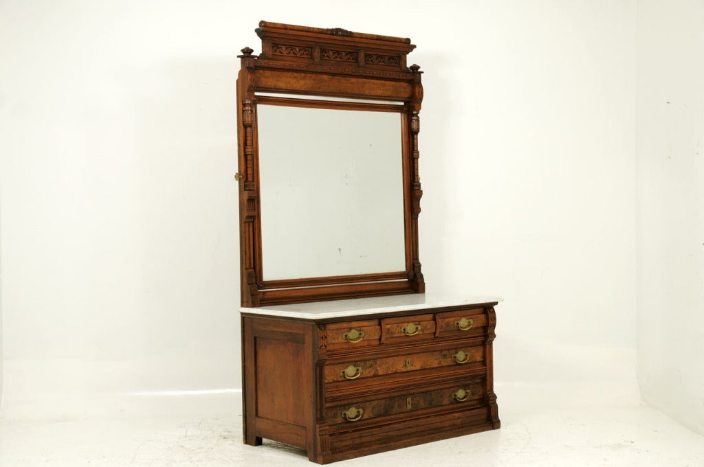 Late 19th century, extremely tall solid walnut dresser with original white bevelled marble with swing mirror above, burled walnut drawer fronts with all original brass hardware.
 
Shipping will be $450 – $500 by Plycon.