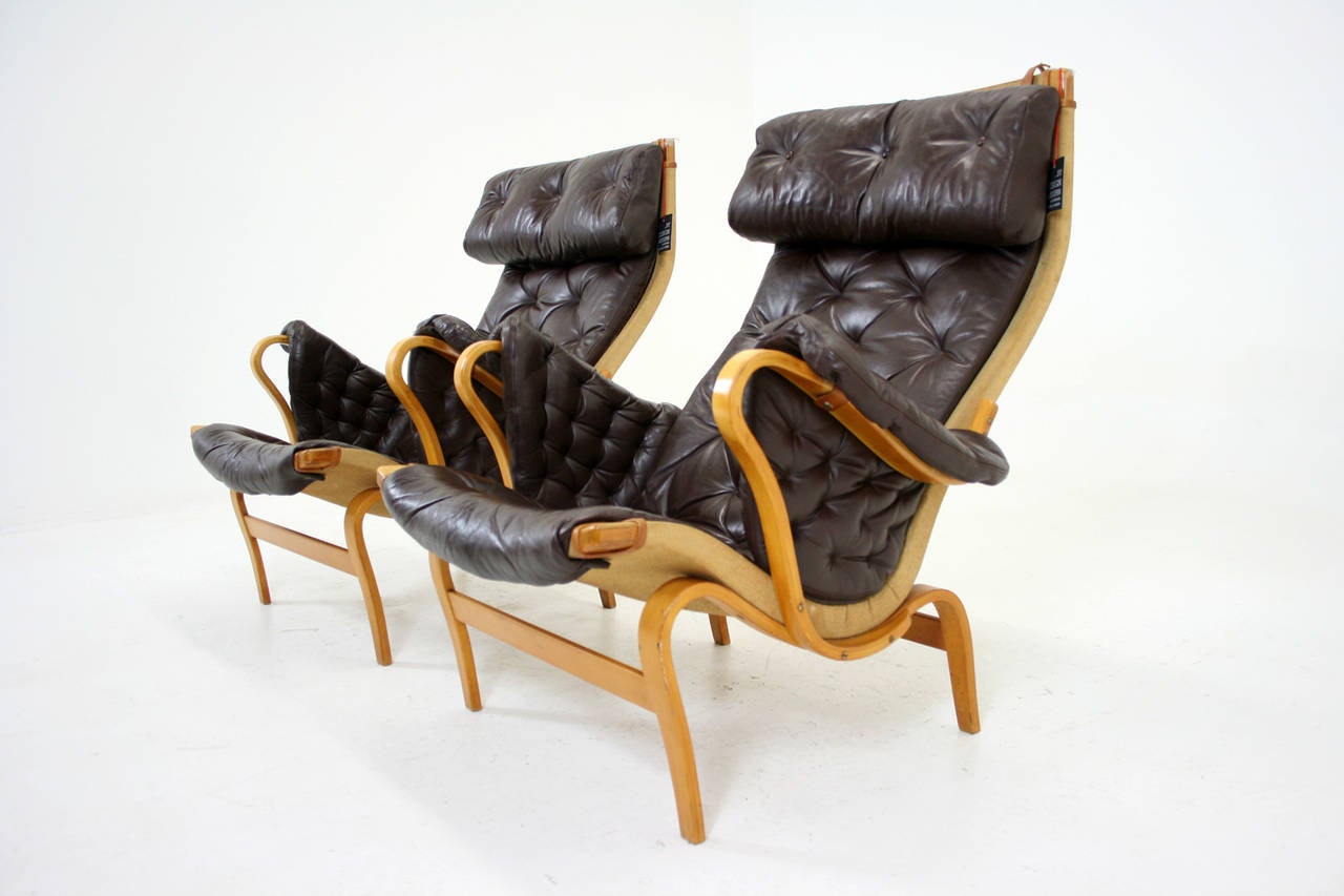 -$2795
-Danish, 1960s
-Steam bent beech plywood construction
-Designed by Bruno Mathsson
-Produced by DUX
-Original finish is in good condition
-Leather in good condition, one small hole to seat
-One leather strap is broken (shown)
-35″W x