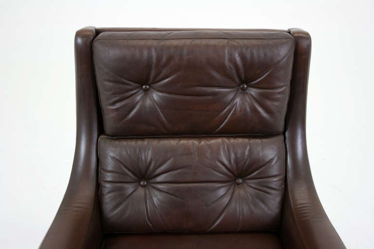 Beautiful Danish leather & rosewood tall lounge chair in original brown leather, dating to the 60′s. Great lines to the piece and is very comfortable. Perfect for condo or apartment living this chair has a very compact footprint and will add loads