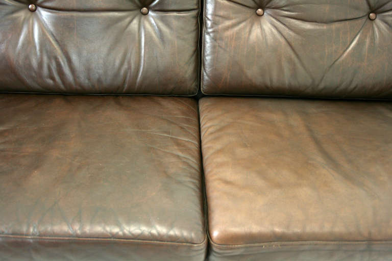 Beautiful Danish leather & rosewood sofa in original brown leather, dating to the 60′s. Great lines to the piece & is very comfortable. Perfect for condo dwelling & will add loads of style to your vintage or contemporary living space. Leather shows