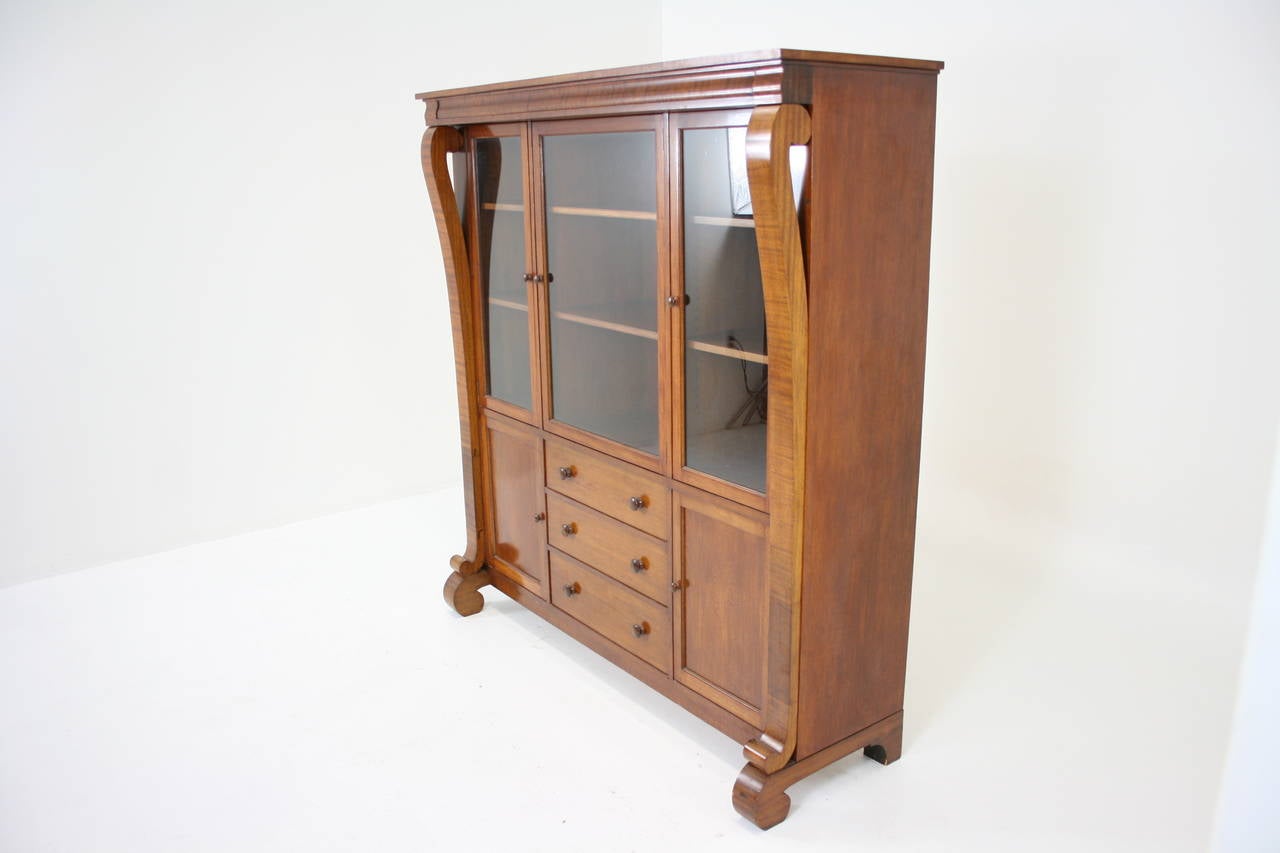 - $1650.
 - American, 1930.
 - Mahogany plus mahogany veneer.
 - Original finish.
 - Glass top section with adjustable shelves.
 - Fitted bottom section.
 - Dovetailed drawers.
 - Minor scratches, chips.
 - Measures: 65