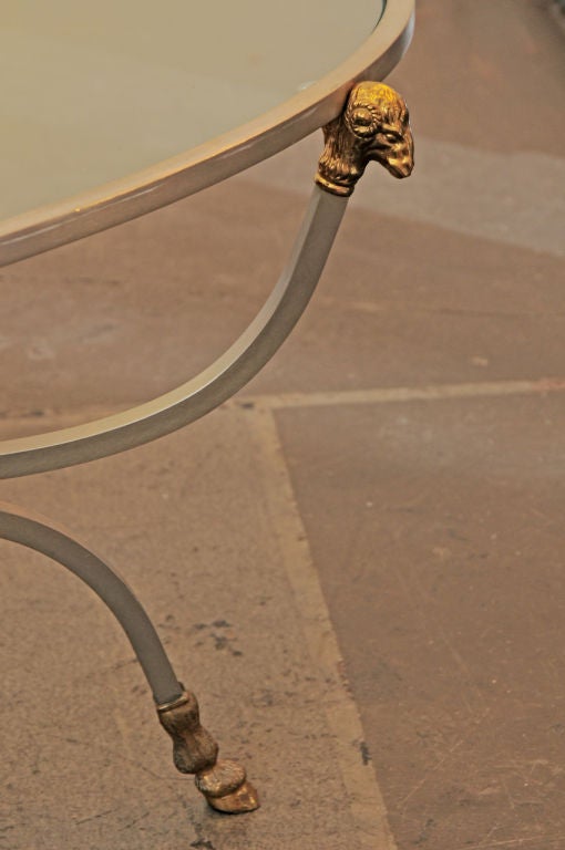 Classic Rams head Maison Jansen coffee table. Oval glass insert iron and bronze.