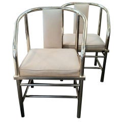 Pair of brass horse shoe arm chairs .By Karl Springer
