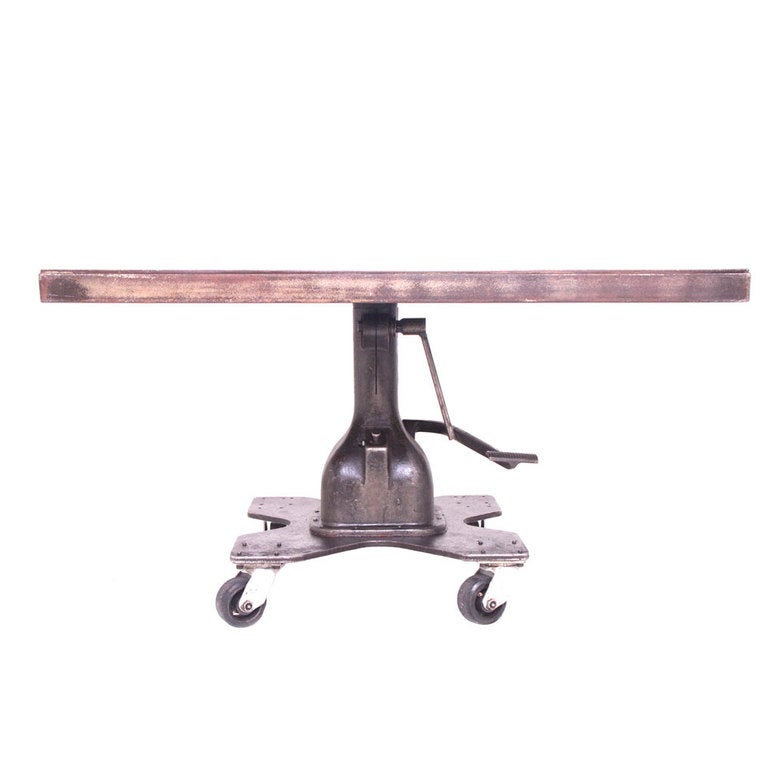 This is an amazing square industrial dining or work table.  The table easily rotates by simply turning the top.  the pedal easily lifts the table to your desired hight and a button easily lowers the table. excellent patina and in excellent