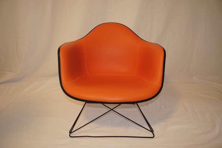 Rare Eames molded sculptural lounge chair with cat's cradle base.  This classic mid century modern lounge chair was designed and manufactured by Herman Miller.  Herman Miller logo embossed in the fiberglass shell.  Great side chair.