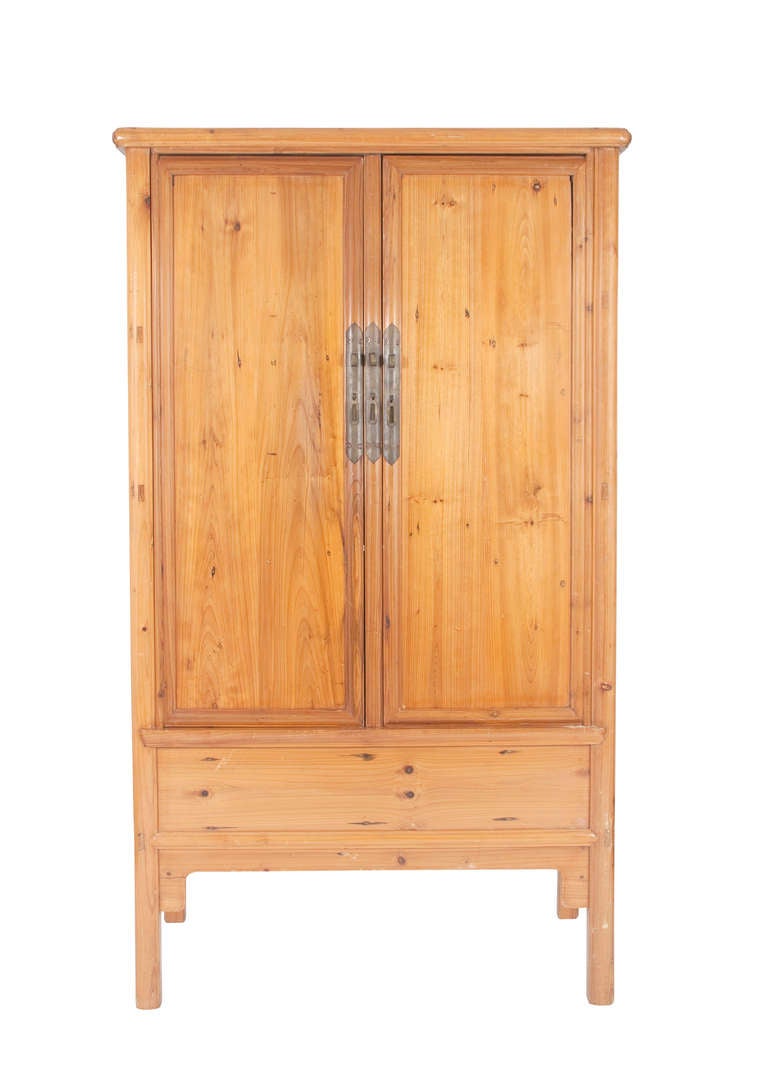 Pine Wardrobe with Asian elements and hardware. Two cabinet doors open to reveal interior shelving fitted to hold a flat screen tv and components below.