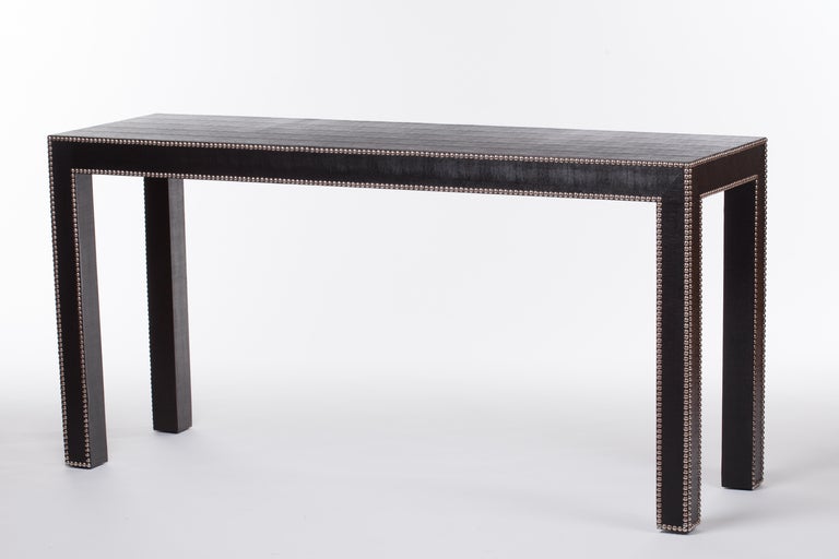 Classic 1960's /70's black faux lizard parson's console table has nailhead studding along table edges for added definition.
