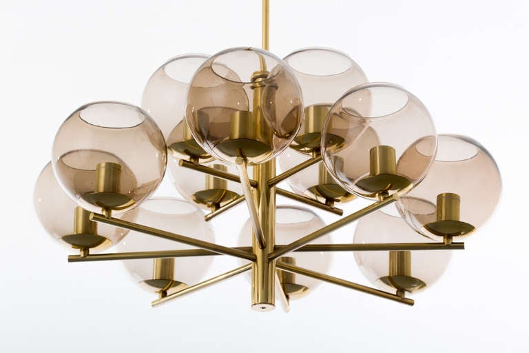 German 1970's brass and smoke glass chandelier has 12 lights with 25 maximum wattage per socket.