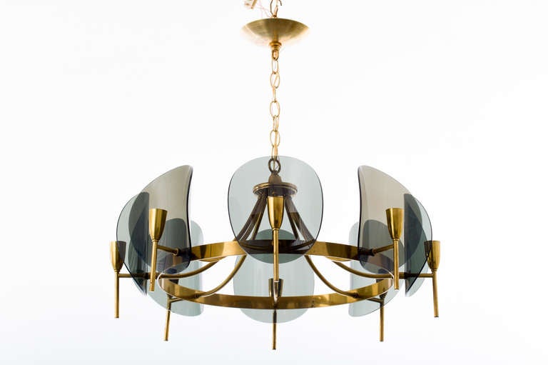 Concave smoked lucite disc chandelier with brass frame, has 8 sockets with 60 max wattage per socket.