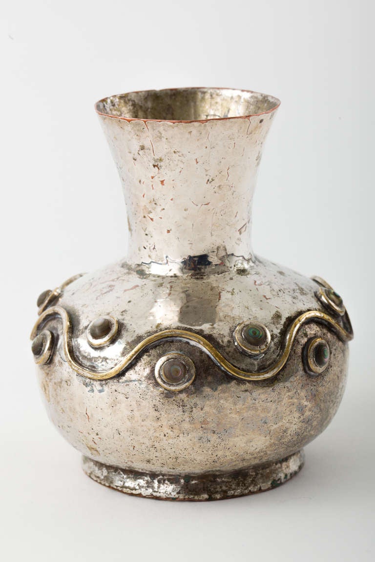 Finely crafted hand-wrought silver over copper vase with abalone inlay detail. Silver finish has wear.
Signed Los Castillo, Taxco, Mexico.