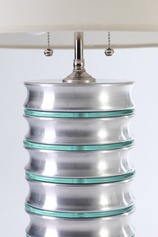 Pair of scalloped aluminum and glass disc column machine age style lamps. 
Double socketed, with nickel-plated solid brass hardware. 

