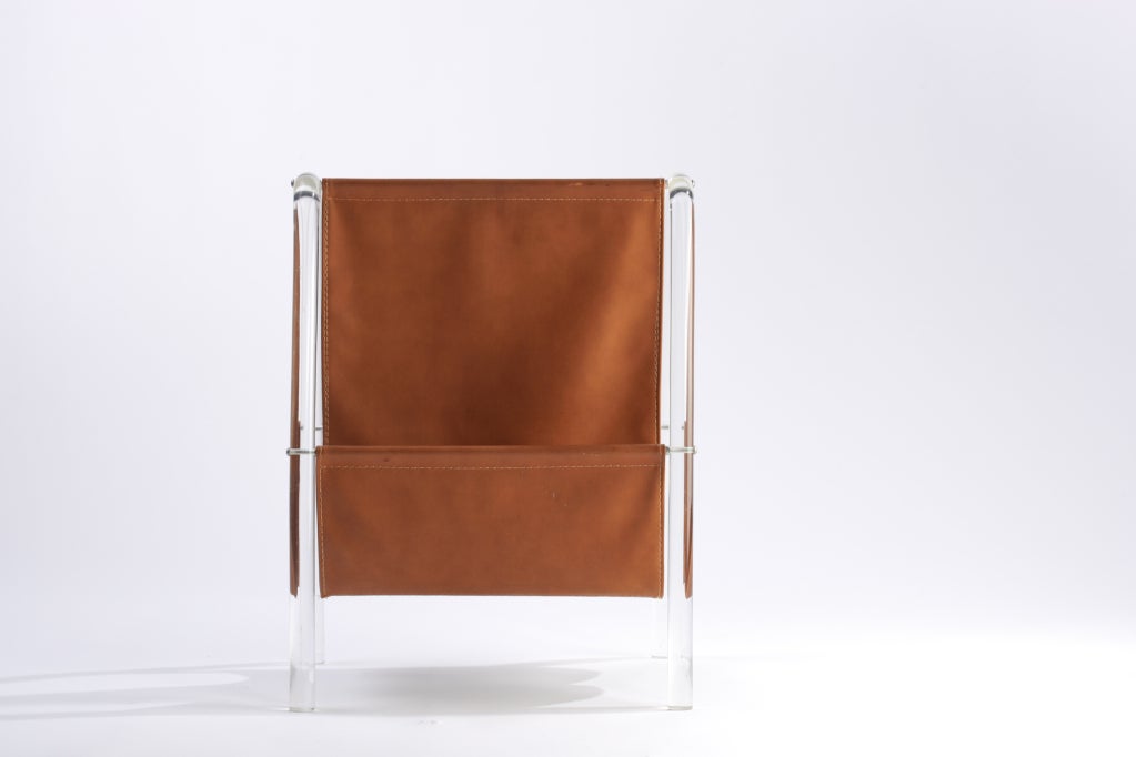Curved Lucite frame and faux leather magazine holder.