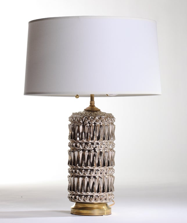 Geometric pattern mercury glass lamps with circular brass bases. 
Rewired with solid brass hardware, with double sockets and pull chains.
100 Watts max per light bulb socket, 2 sockets per lamp.