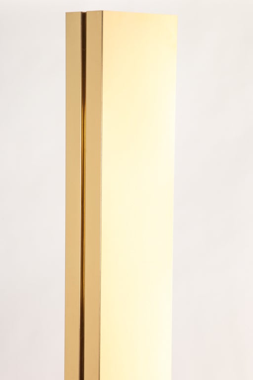 Brass rectangular column floor lamp illuminates by touching either side, or both for more light. Light dims or brightens with sweep of hand up or down brass column.