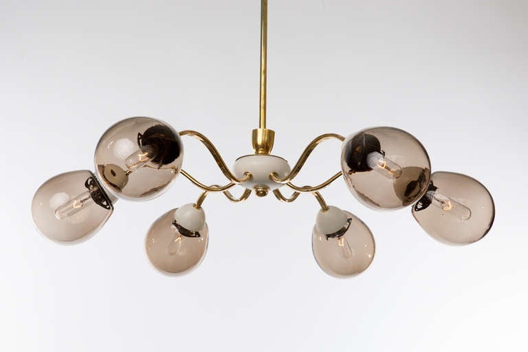 1970s German brass frame chandelier with six smoke glass globes. Brass rod and ceiling cap.