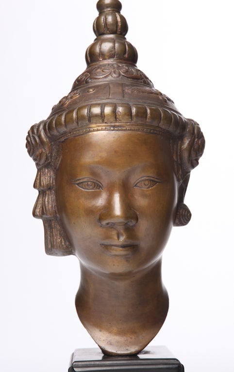  Southeast Asian figural cast metal sculpture on black lacquered cube base.