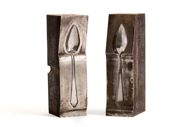 A pair of solid steel spoon mold sculptures by a company producing sterling silverware for Tiffany & Company. Wonderful as sculptures or bookends on etagere.