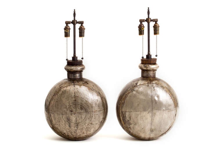 Pair of large Indian metal water vessel lamps with wood stoppers. Double socketed with patinated solid brass hardware.