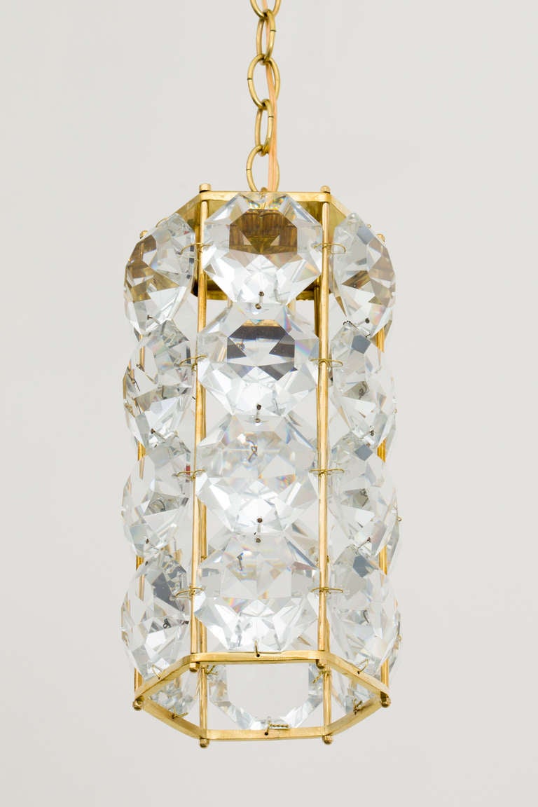 Pair of German 1960s hexagonal faceted crystal chandeliers with gilt brass frame. Frame measures 13.5 inches height x 6.5 inches diameter.
 One socket, 150 max wattage each.