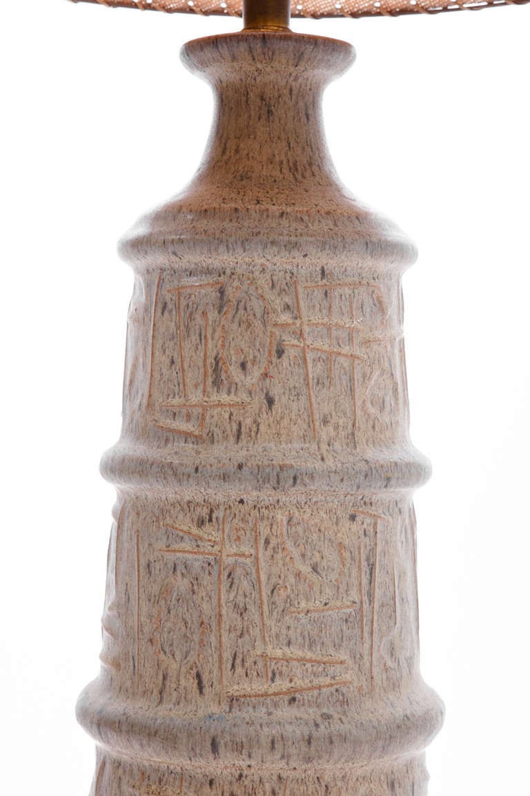 Monumental Italian ceramic lamp with abstract design in low relief, on circular wood base. Solid brass finial. Made by Bitossi, circa 1950. Original shade is worn, though available as template.
