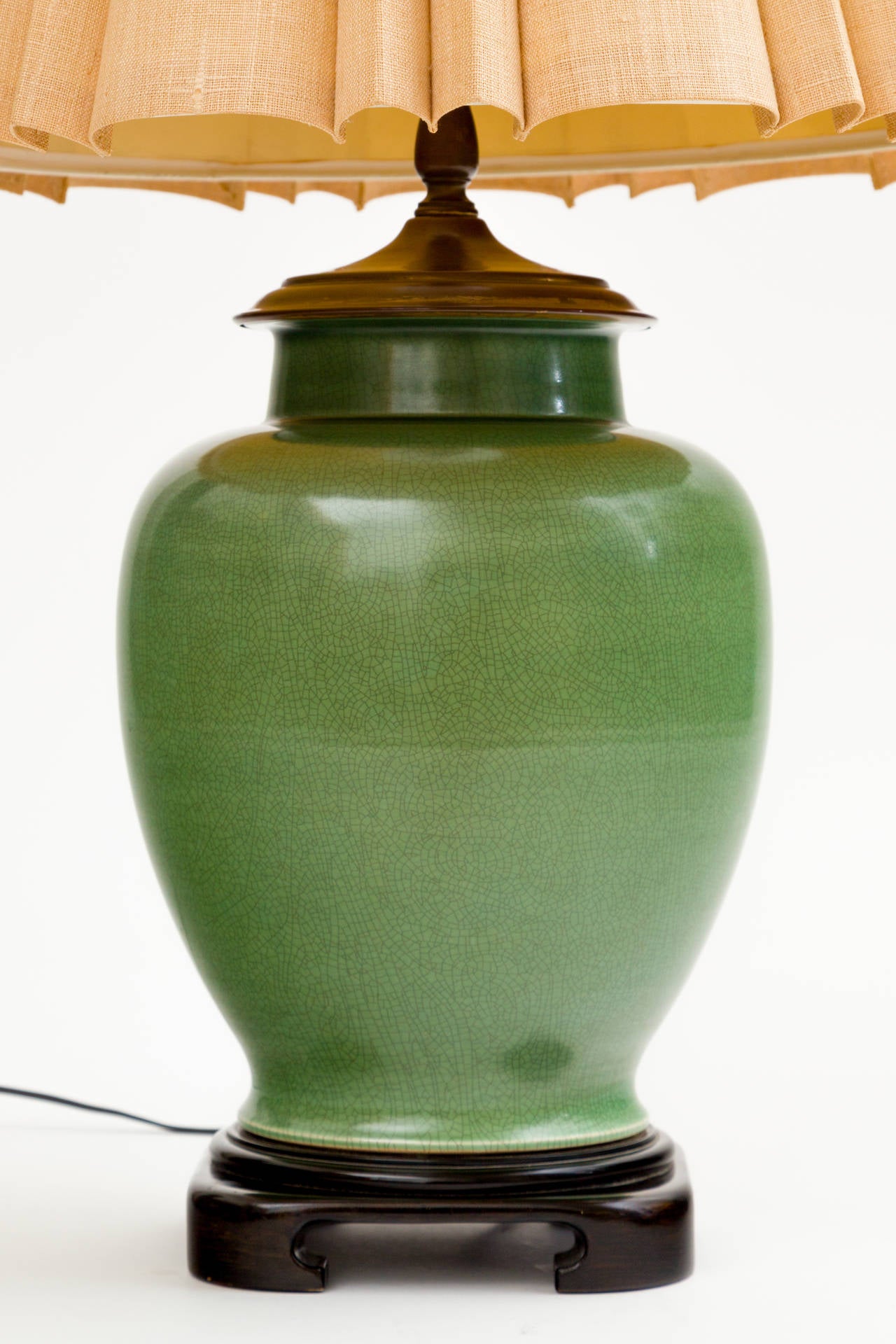 Jade ceramic ginger jar lamp on ebonized wood base. 
Solid brass Chinese 