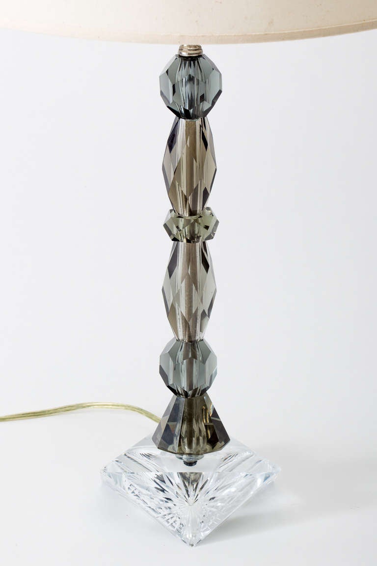 Pair of luxurious faceted smoke glass lamps on clear crystal bases. Solid nickel plated brass hardware, newly rewired.