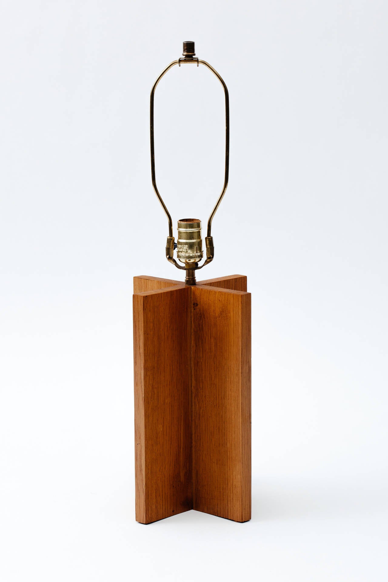 Solid oak cruciform base table lamp with solid brass hardware after the design by Jean Michel Frank.
 

