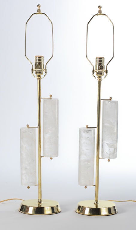Solid rock crystal cylinders are hand-carved and attach to solid brass lamp posts and circular bases, brass finials.