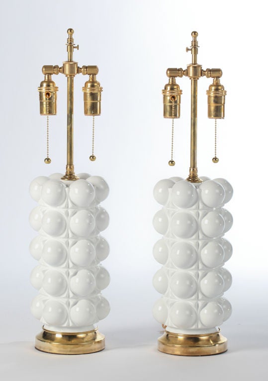 White lacquered glass bubble lamps with brass bases., dated 1972 inside glass rim at base. Double socketed, solid brass hardware.