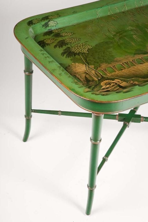Rare English Regency papier mâché tray, circa 1820, on later stand. A capriccio view painted on a green ground.