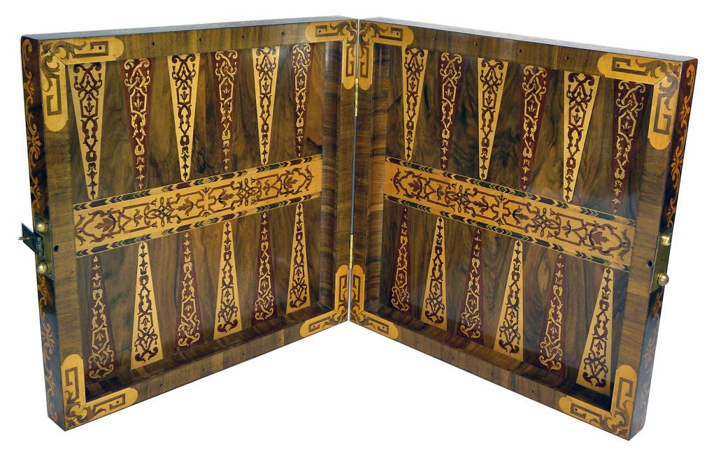 One side with an elaborately inlaid chess board, the other side inlaid for 'Muehle' (Nine Mens Morris); opening to an inlaid backgammon surface; exotic woods throughout.
w 18.75 d 18.75 h 3.75 
open 37.5