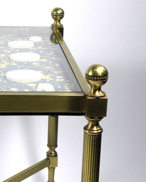 Pair of low tables with early 19th century Italian Grand Tour plaster intaglios; depicting classical figures and busts mounted on marbleized paper under glass; the polished brass tables are modern.